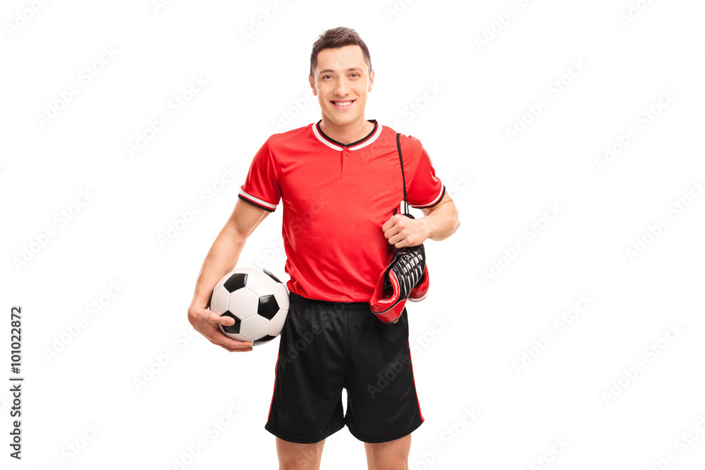 Football player carrying a pair of boots Football player carrying a pair of boots