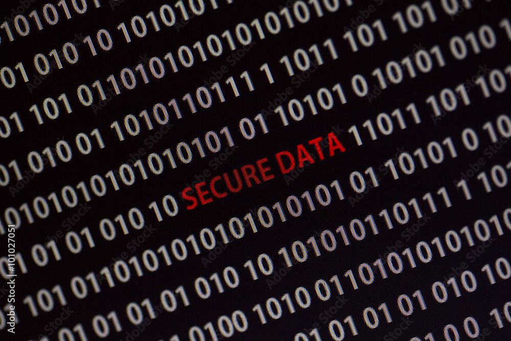 'Secure data' text in the middle of the computer screen surrounded by numbers zero and one. Image is taken in a small angle. 'Secure data' text in the middle of the computer screen surrounded by numbers zero and one. Image is taken in a small angle.