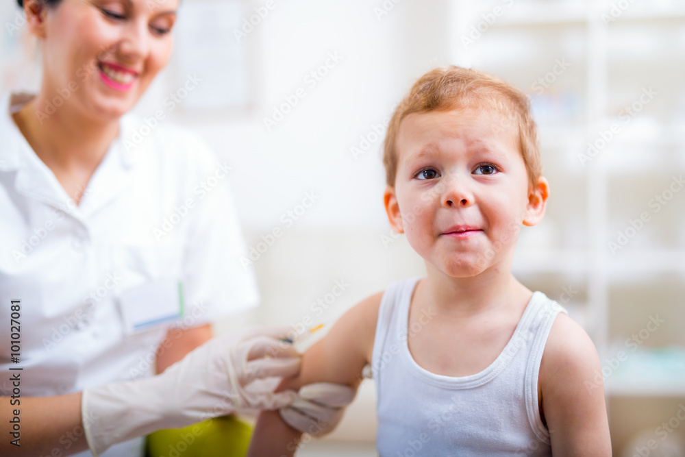 Pediatrician makes vaccination to small boy Pediatrician makes vaccination to small boy