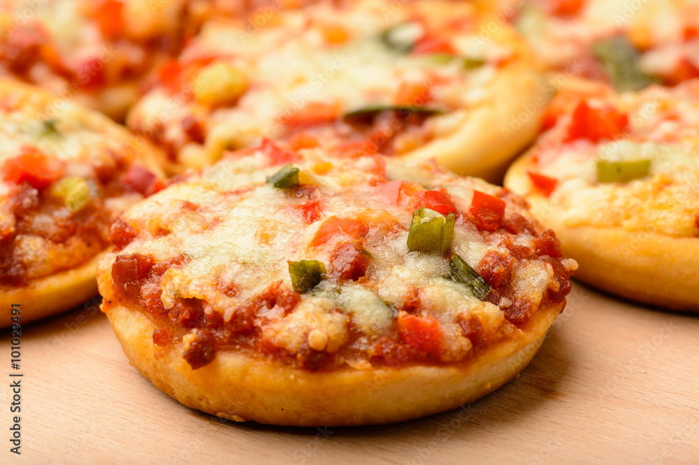 Mini pizzas on wooden board. Mini pizzas on wooden board.