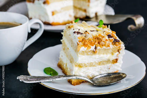 Serving cake with a creamy cream and nuts