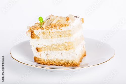 Serving cake with a creamy cream isolated on white