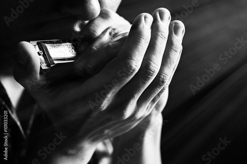 Musician plays the harmonica photo