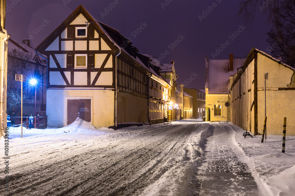 Narrow snowy street with half-timbered residential houses. Market street. Old town of Klaipeda city, Lithuania