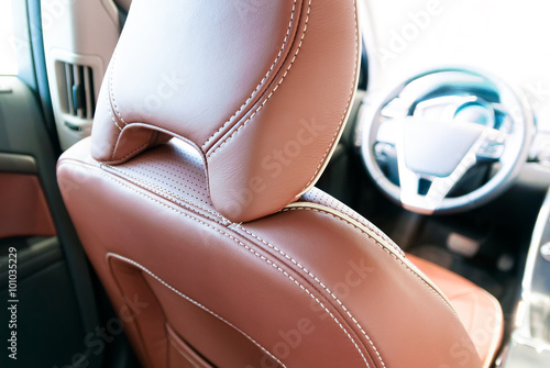 red leather luxury car interior , view from back seat headrest and steering wheel © gargantiopa
