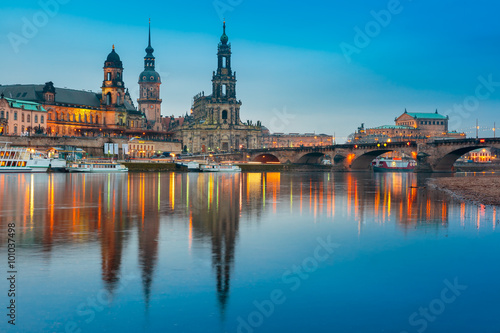 Dresden Cathedral of the Holy Trinity or Hofkirche, Bruehl's Terrace or The Balcony of Europe, Semperoper and Augustus Bridge with reflections in the river Elbe at night in Dresden, Saxony, Germany © Kavalenkava
