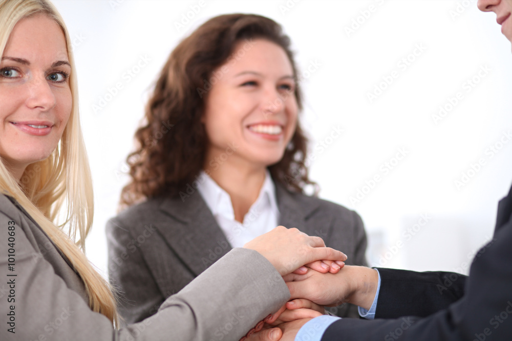 business people group joining hands and representing concept of friendship and teamwork business people group joining hands and representing concept of friendship and teamwork