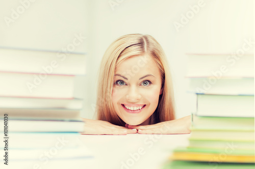 student with stack of books