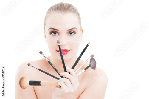 Beautiful woman holding makeup brushes