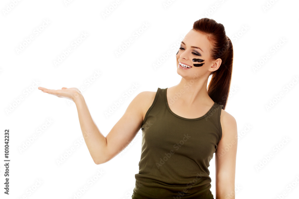 Young soldier woman presenting something on open palm Young soldier woman presenting something on open palm
