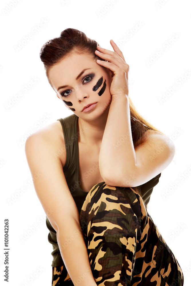 Fototapeta premium Ypung beautiful soldier woman sitting on the floor
