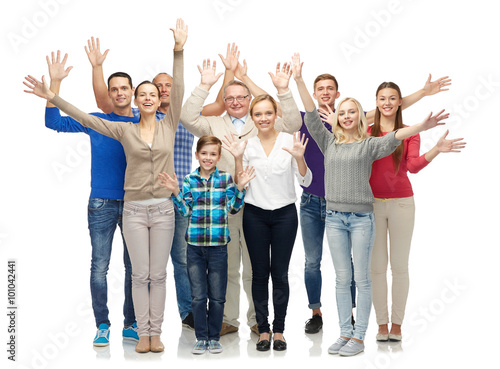 group of smiling people waving hands