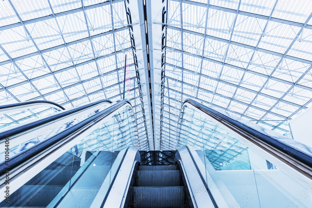 Fototapeta premium Escalator at the airport. Blue colored.