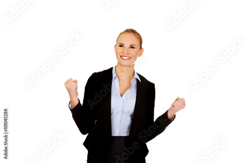 Young happy business woman with arms up