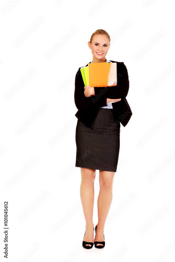 Smiling business woman holding notebooks Smiling business woman holding notebooks