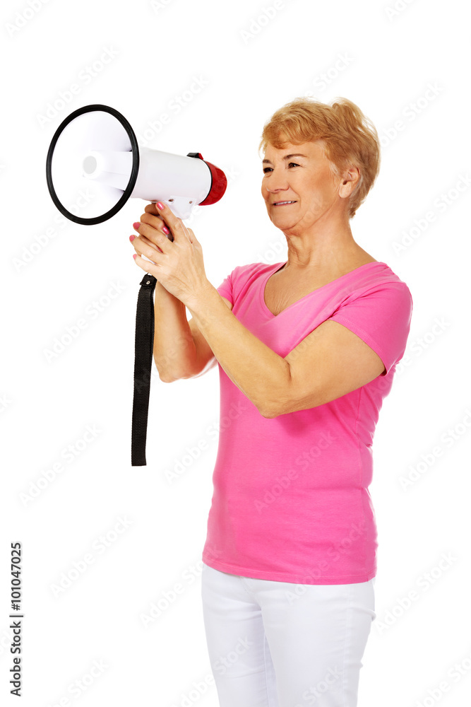 Senior smiling woman screaming through a megaphone Senior smiling woman screaming through a megaphone