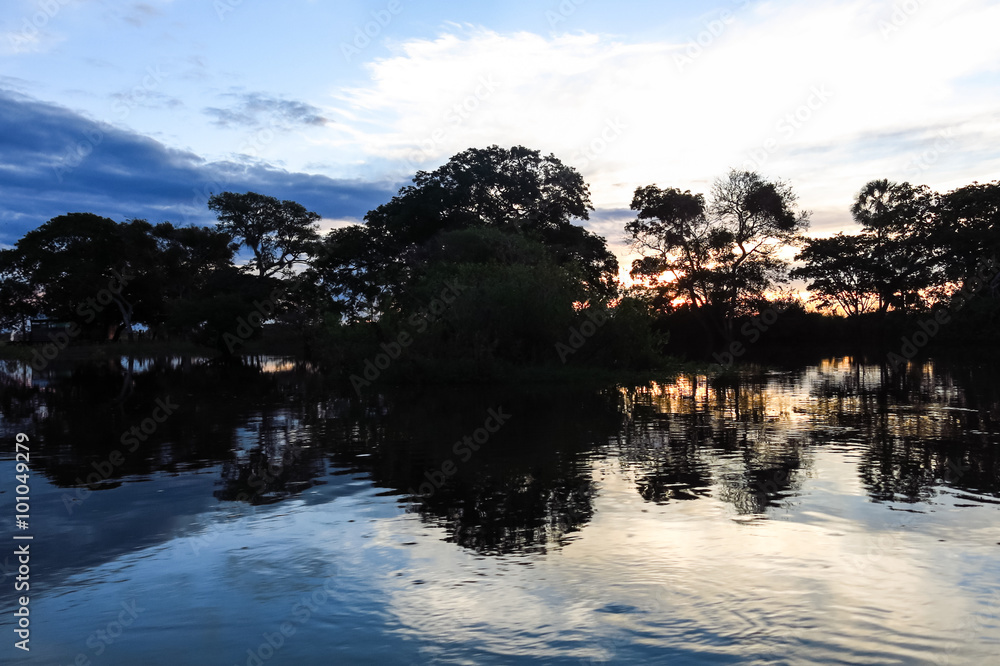 Obraz premium Sunset. Boat Crossing the Amazon.