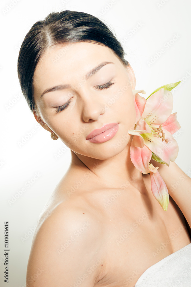 Fototapeta premium Beautiful lady with lilly flower. Perfect skin.