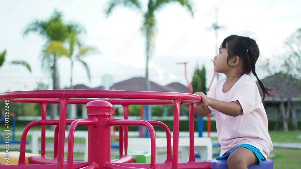 Little girl riding on a carousel.Spinning, Rotating on a Merry-Go-Round in Park.
Little girl riding on a carousel.Spinning, Rotating on a Merry-Go-Round in Park.