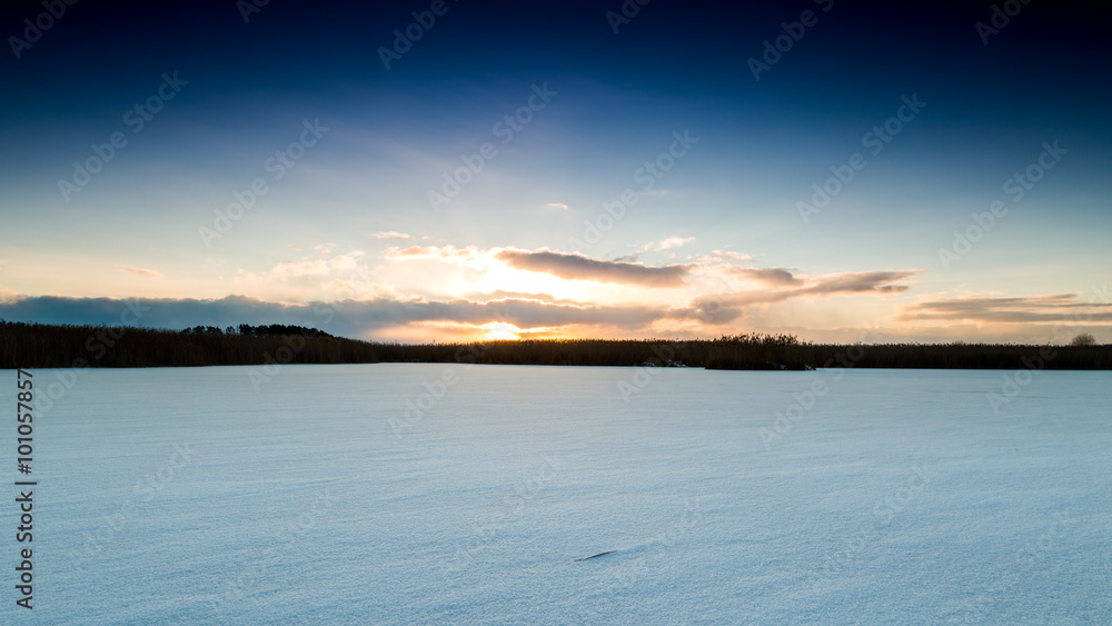 Sunset over snowy fields