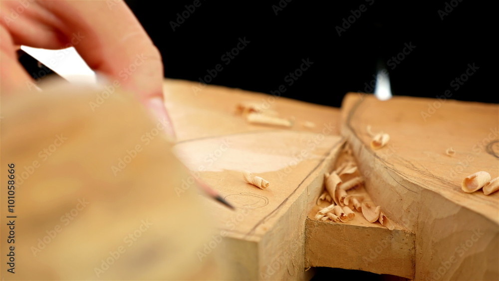 Wood carving - Human hand drawing over a piece of wood Wood carving - Human hand drawing over a piece of wood