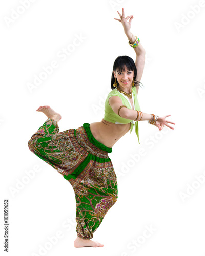 full length portrait of indian woman dancing in studio.  Isolated on white