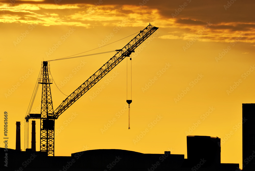 The end of the working day on the construction of a house in Saint-Petersburg on sunset background. The end of the working day on the construction of a house in Saint-Petersburg on sunset background.