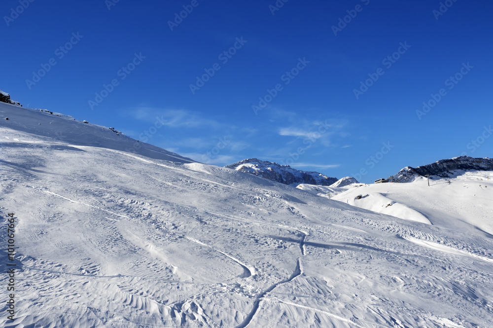 Off-piste slope at sun day