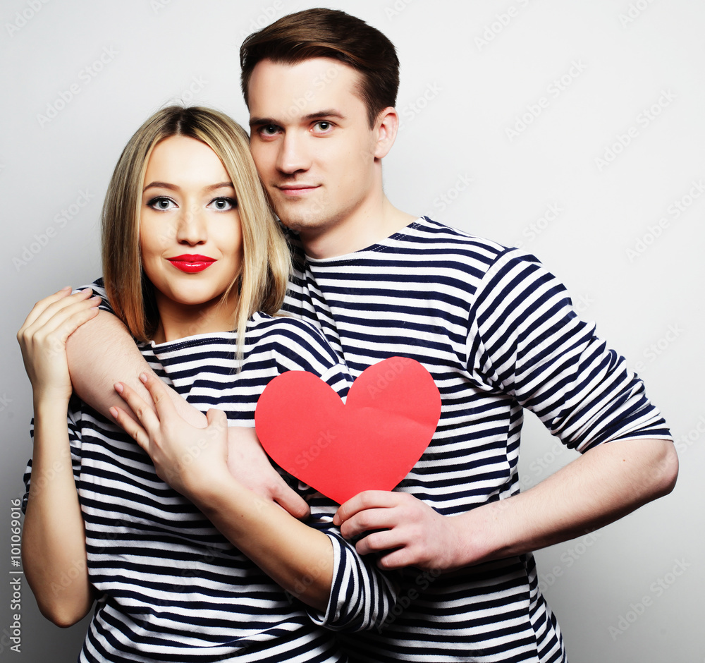 Happy couple in love holding red heart Happy couple in love holding red heart