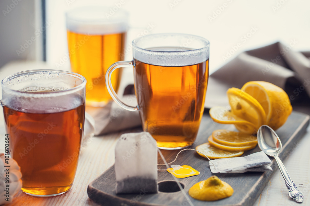 Shot of glass cup of tea with lemon on wood table Shot of glass cup of tea with lemon on wood table