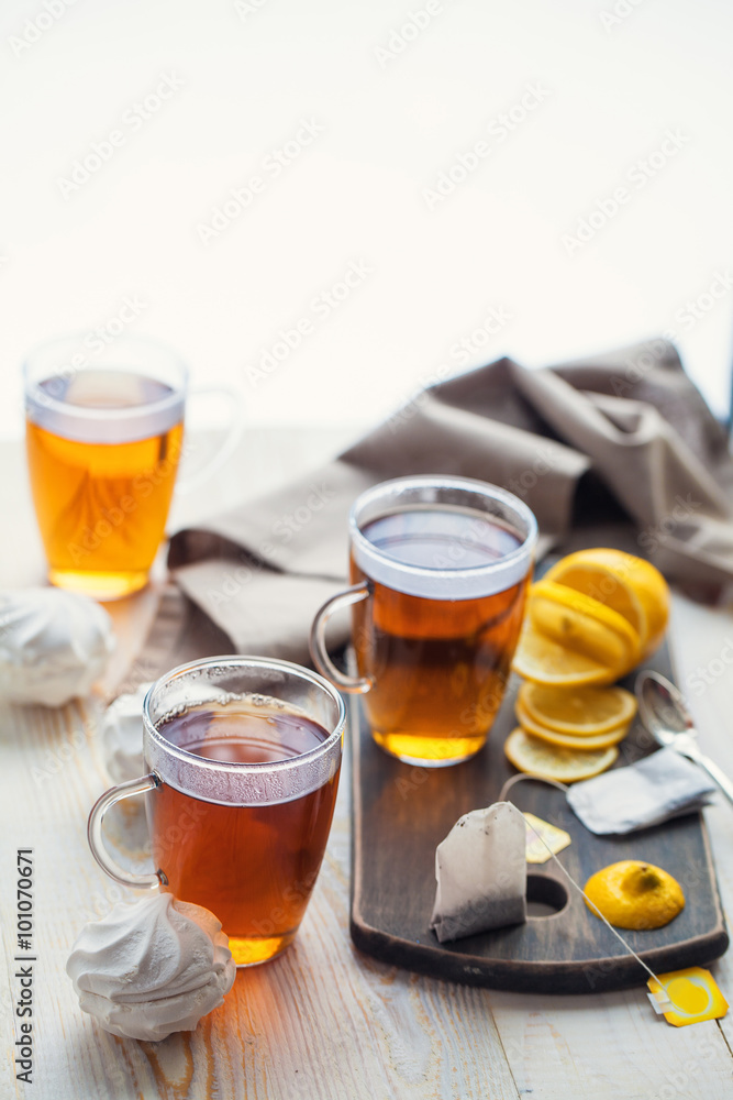 Shot of glass cup of tea with lemon on wood table Shot of glass cup of tea with lemon on wood table