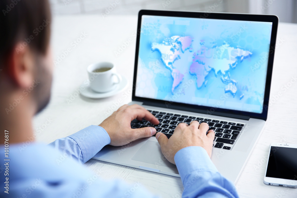 Human working with laptop, with world map and network on screen Human working with laptop, with world map and network on screen
