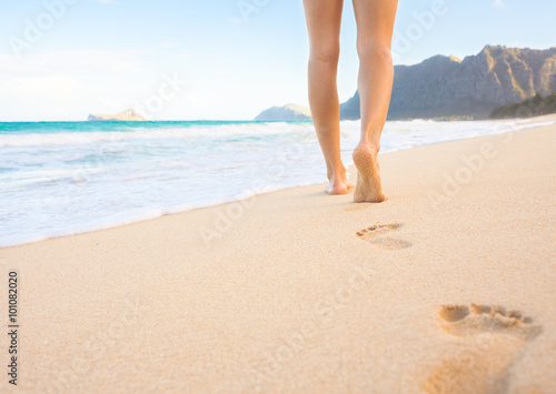 Woman walking on the beautiful beach in Hawaii.