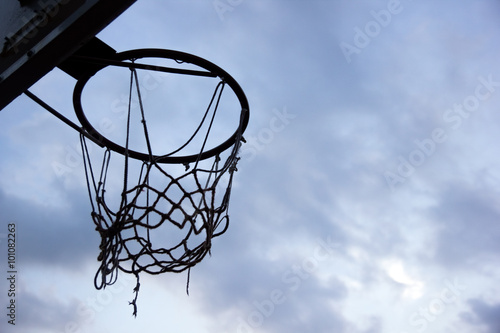 Basketball goal. Silhouette of a basketball ring and net on sky  © projectio