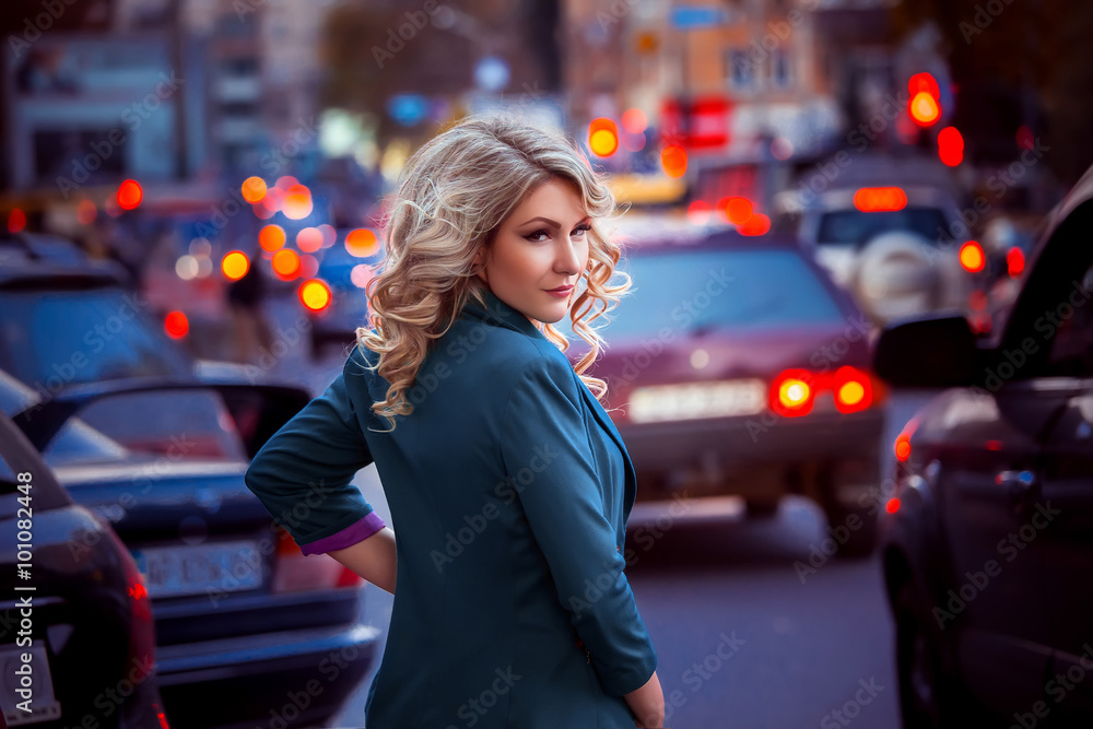 Fototapeta premium Beautiful stylish woman in a coat and hat with long walks through fields autumn city,business women,lady in the city,creative computer colors,fashionable toning
