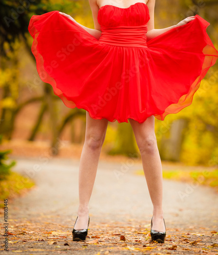 Fashion woman red dress relaxing walking in park