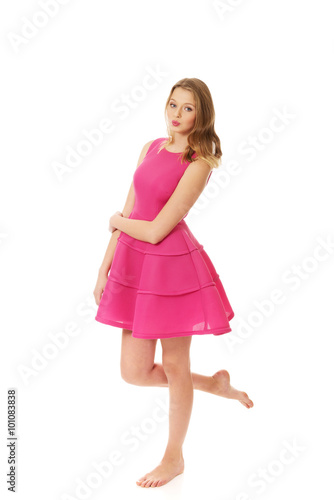 Young blonde woman with pink skirt 