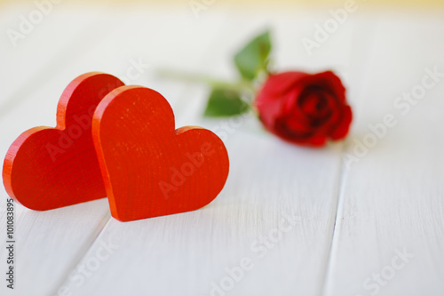 Stock Photo:.Red wooden heart on white wooden boards,