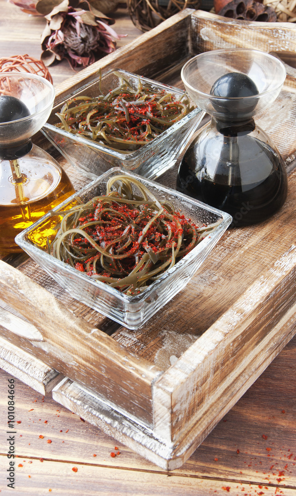 seaweed and chopsticks, on an open wooden table