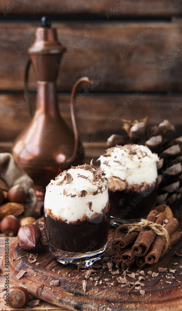 hot chocolate in glass cups and cream with nuts