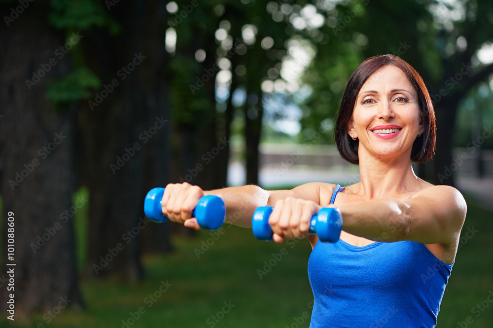 Portrait of cheerful aged woman in fitness wear exercising with Portrait of cheerful aged woman in fitness wear exercising with