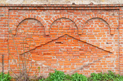 Ancient cut away brick wall with decorative arches and rhomb of Transfiguration monastery based on 1525 in Belyev city. Tulsky region, Russia. 
 photo