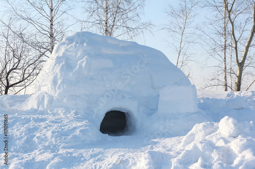 The dwelling an igloo on a snow glade in the winter at sunset