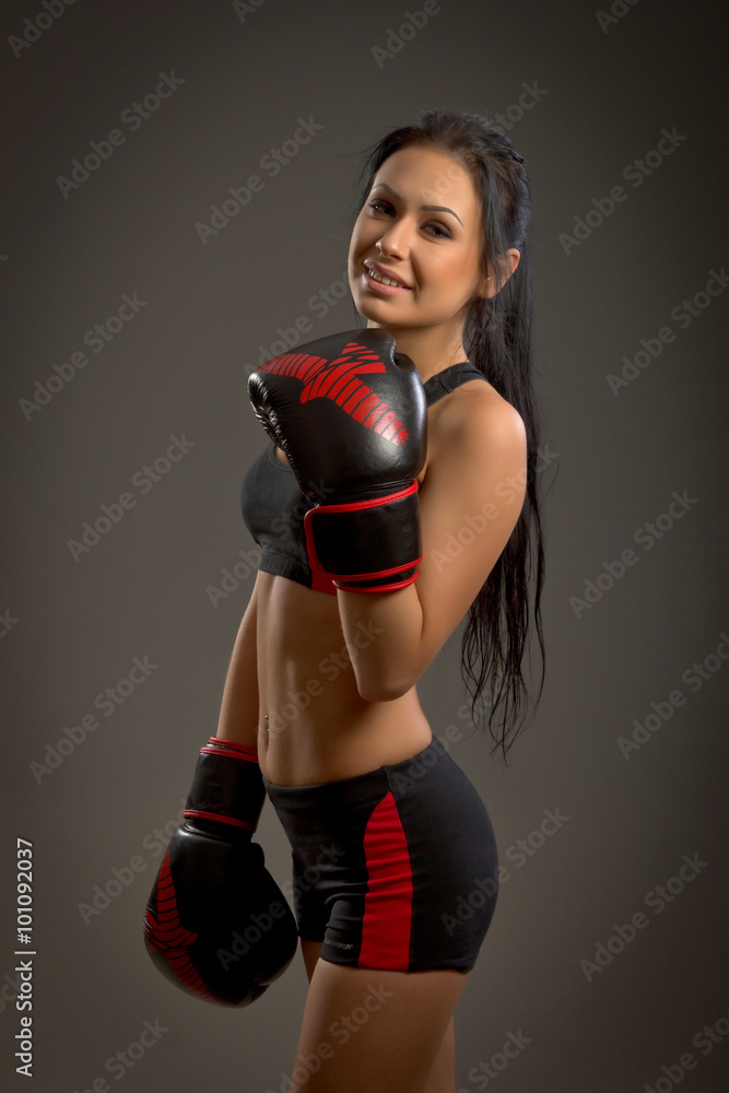 Girl boxer on a dark background