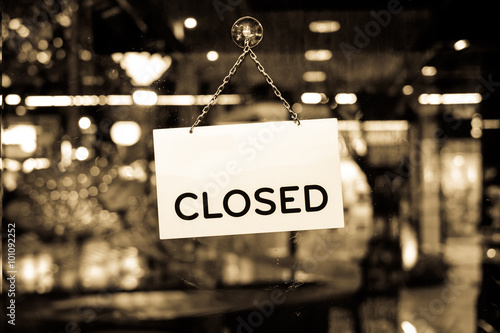 A closed sign hanging in a shop window