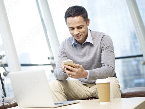 man using cellphone at workplace photo