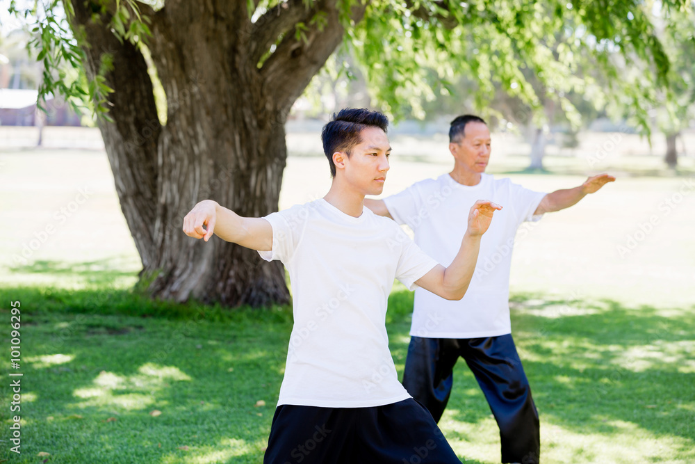 People practicing thai chi in park People practicing thai chi in park