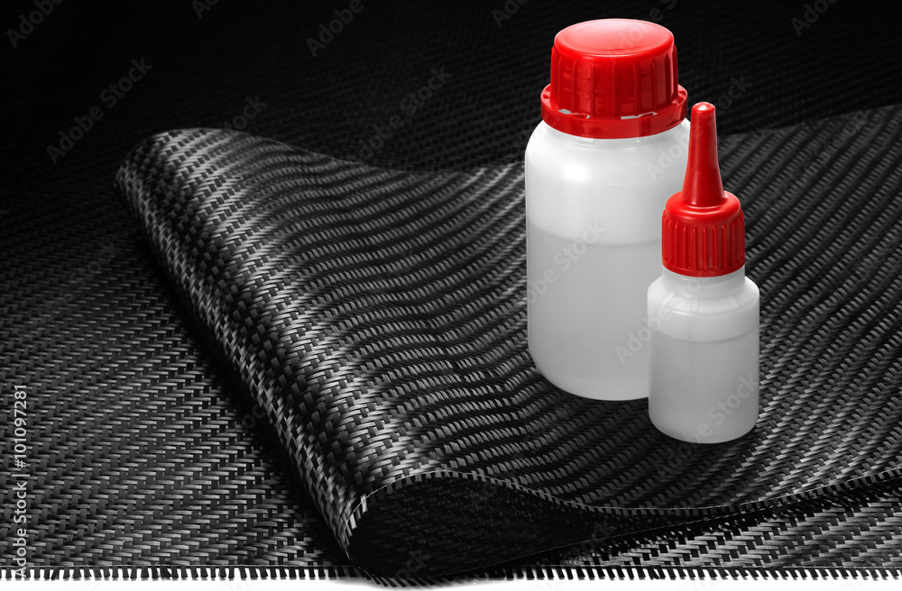 Carbon Fiber Cloth Fabric, epoxy resin and hardener. Stock Photo
