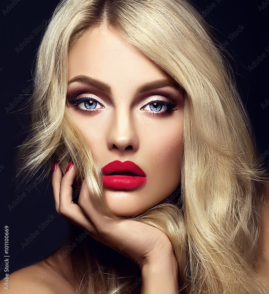 sensual glamour portrait of beautiful blond woman model lady with bright makeup and red lips touching her face , with healthy curly hair on black background sensual glamour portrait of beautiful blond woman model lady with bright makeup and red lips touching her face , with healthy curly hair on black background