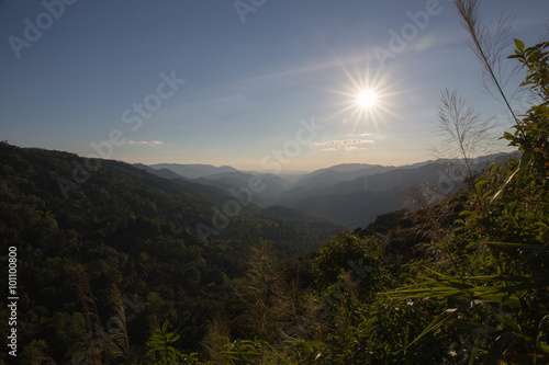 silhouette sun and range of mountain at tropical rain forest in